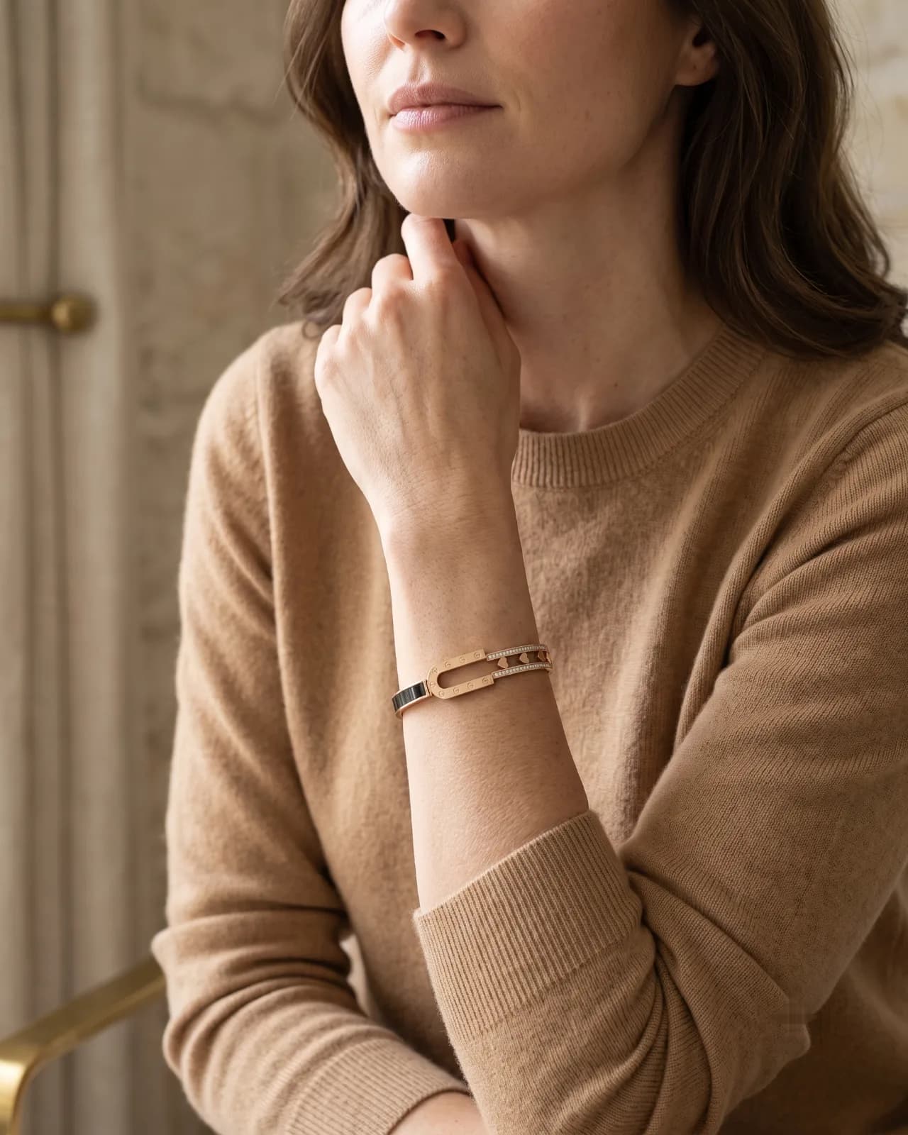 Aurelle Hinged Cuff bracelet resting on a marble surface with dried flowers