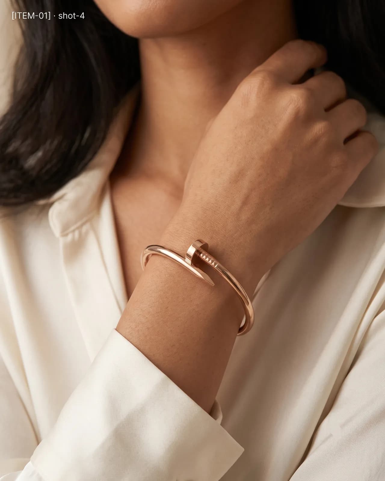 Élise Nail Cuff bracelet resting gracefully on soft fabric