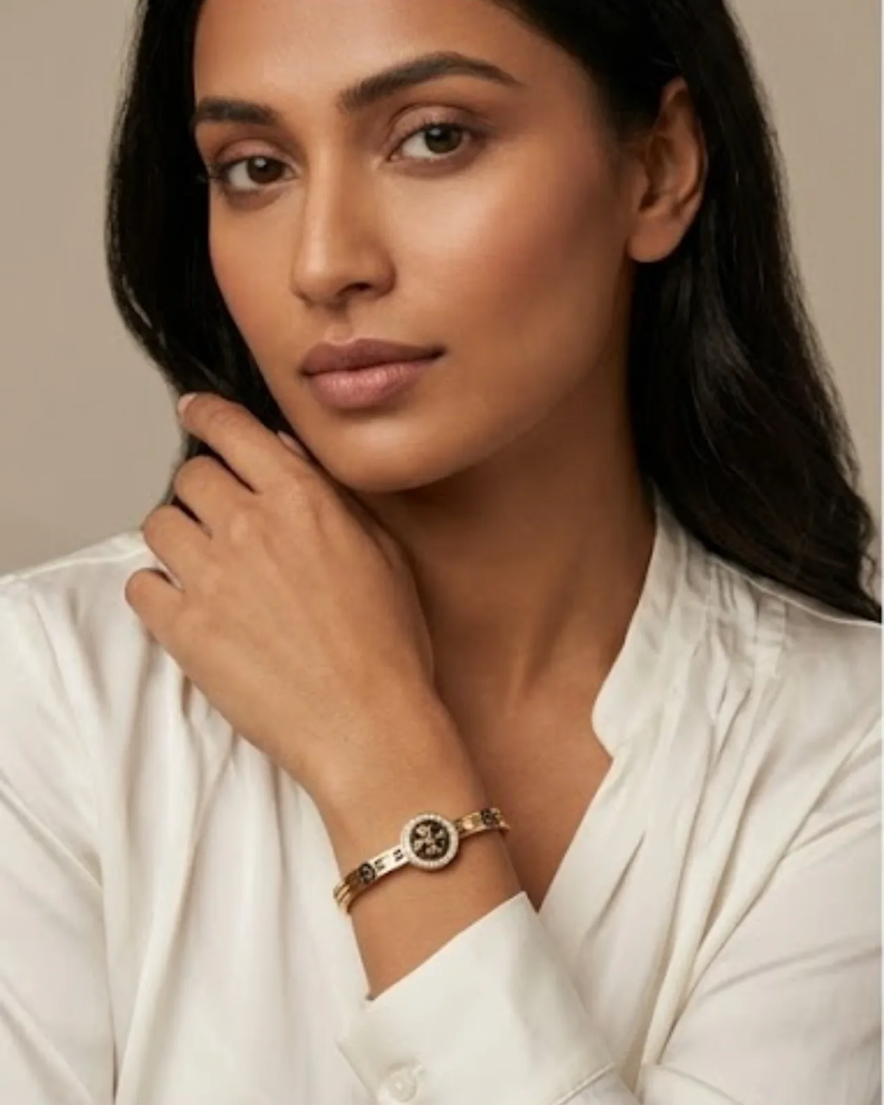 Étoile Logo Cuff bracelet resting on a soft draped fabric