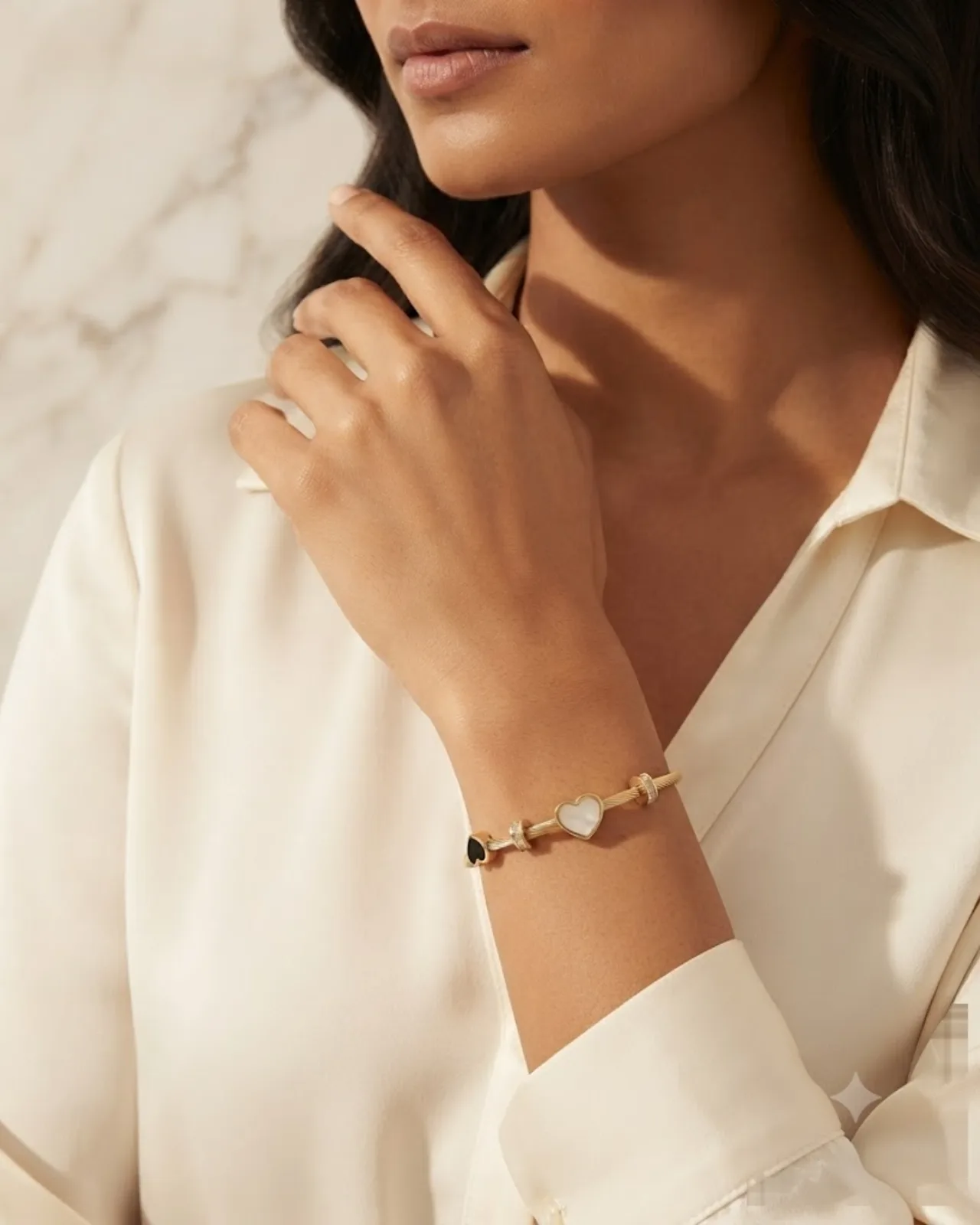 Amélie Heart Bangle resting elegantly on a draped silk fabric
