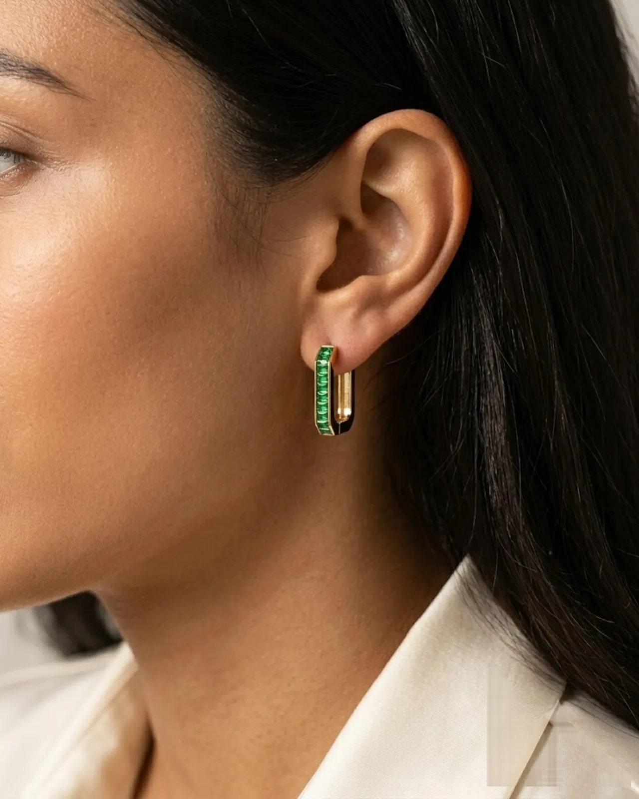 Pair of Élise Emerald Hoops showing rectangular gold frames with green stones