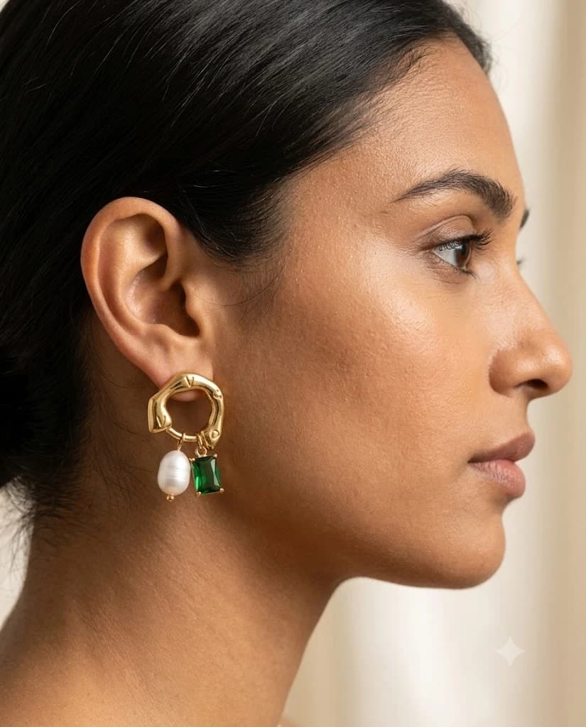 Front view of Aurelle Pearl Drop earrings with pearl and green stone charms