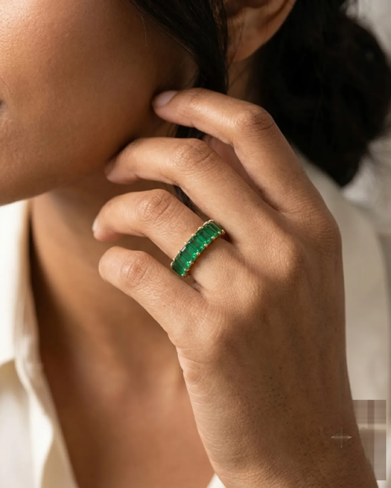 Front view of the Élise Emerald Band showing vibrant green emerald-cut stones